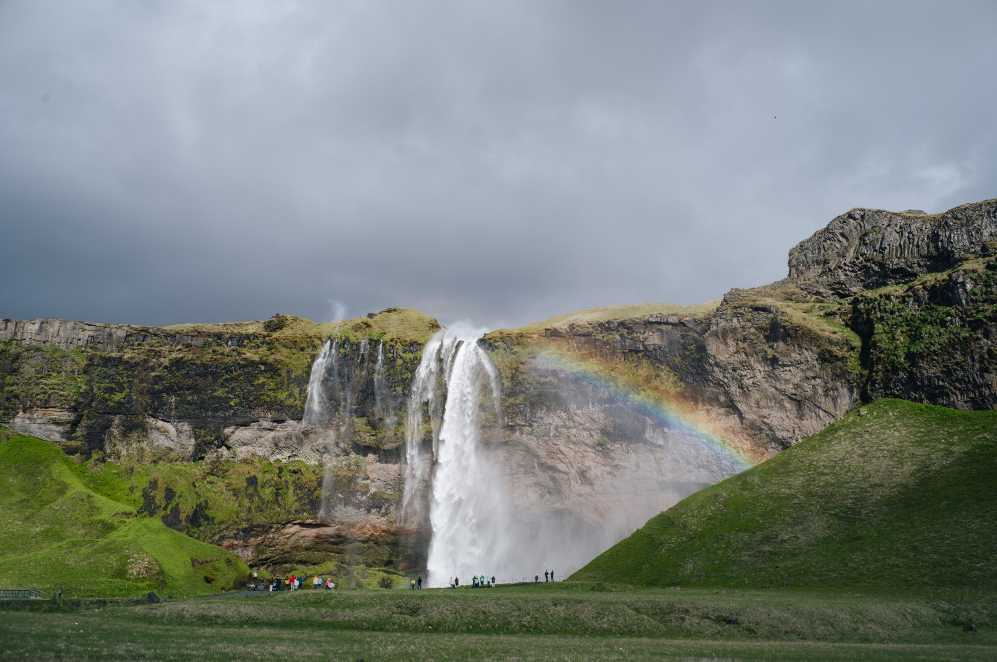 Seljalandsfoss waterfall in Iceland with a rainbow across the spray